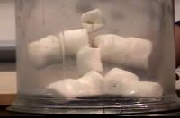 A little man made out of marshmallows in a vacuum chamber