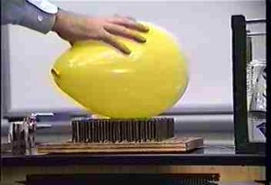 Balloon pressed down into a bed of nails
