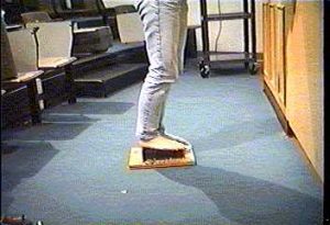 Person standing barefoot on a bed of nails