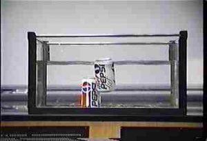 Two cans of soda in a water-filled aquarium