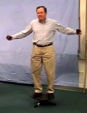 Instructor stands on a platform free to rotate.