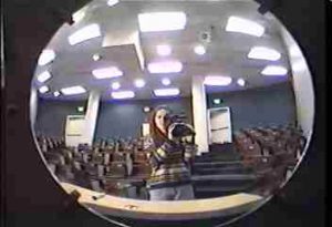 Large concave mirror with image of student
