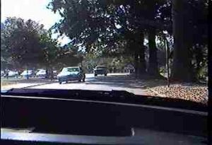 Car approaching another car whose horn is blowing