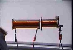 Two coils suspended adjacent to each other, end to end