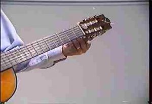 Adjusting the tuning pegs on a guitar