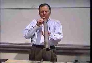 Person blowing an organ pipe